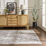 Living room scene with a Mohan Washable Area Rug, wood floors, and a mid-century modern sideboard. Neutral tones and natural light. Roomscene-Rectangle