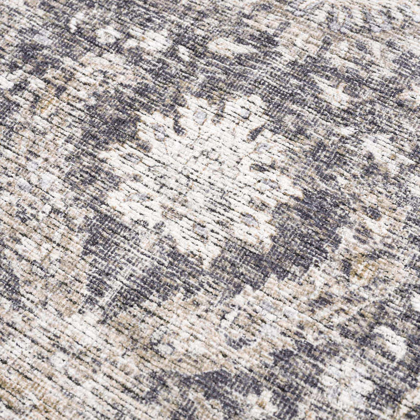 Close-up of the Mohan Washable Area Rug showing a traditional floral pattern in gray, beige, and white chenille polyester. Texture