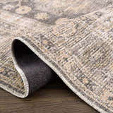 Close-up of the Keola Washable Area Rug showcasing its farmhouse style, neutral colors, and chenille polyester texture. Fold