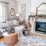 Cozy living room with a Zephyr Area Rug in black, charcoal, and taupe, styled with a fireplace and gray sofa. Roomscene-Rectangle