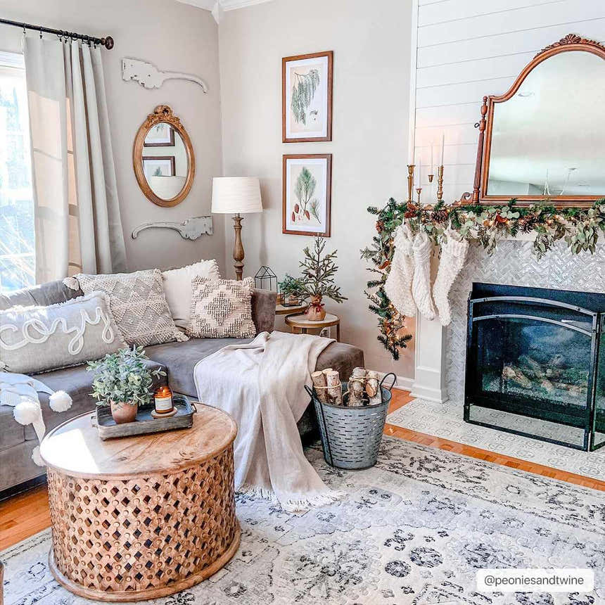 Cozy living room with a Zephyr Area Rug in black, charcoal, and taupe, styled with a fireplace and gray sofa. Roomscene-Rectangle