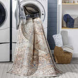 Arncliffe Washable Area Rug in a laundry room being pulled out of a washing machine. Easy clean rug. Washing-Machine