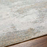 Close-up of the textured Adwoa Boutique Rug. Features cloud gray, nutmeg, and light gray hues with a contemporary design. Texture