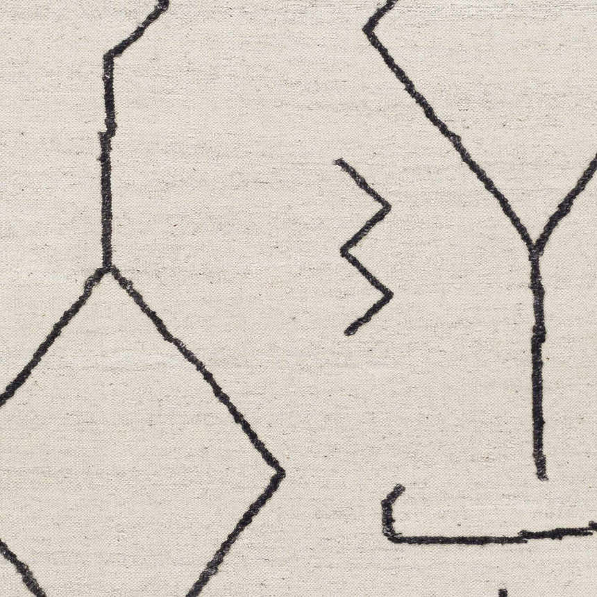 Close up of AISHA area rug, a hand woven contemporary rug with black geometric lines on a cream background. Swatch