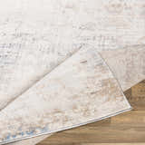 Close-up of the Alcove Abstract Area Rug showing its dark blue, gray, and ivory abstract design and polypropylene texture. Fold