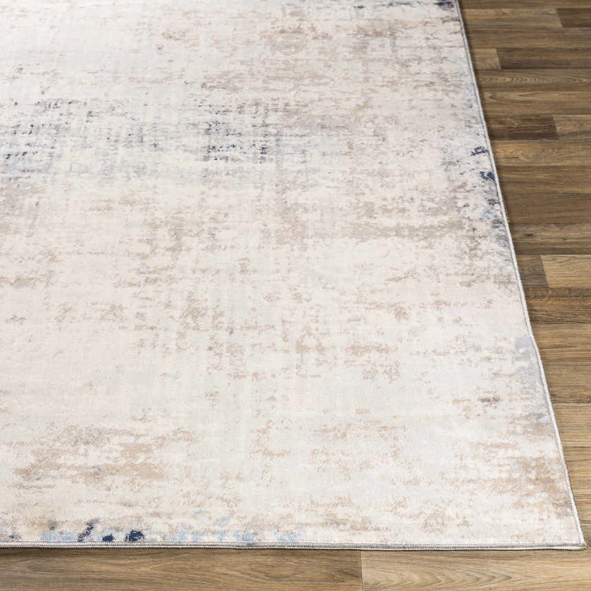 Close-up of the Alcove Abstract Area Rug showing its ivory, gray, and blue contemporary design and soft texture. Front