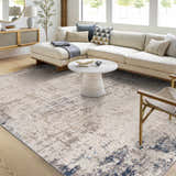 Living room scene with a cream sofa and Alcove Abstract Area Rug in dark blue, gray, and ivory. Roomscene-Rectangle