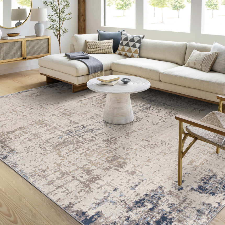 Living room scene with a cream sofa and Alcove Abstract Area Rug in dark blue, gray, and ivory. Roomscene-Rectangle