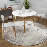 Dining room scene with a round white table on a blue and gray Alcove Abstract Area Rug. Roomscene-Round