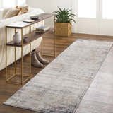 Living room scene with Alcove Abstract Area Rug runner in light gray, ivory, and blue. Styled with console table, plant, and sofa. Roomscene-Runner