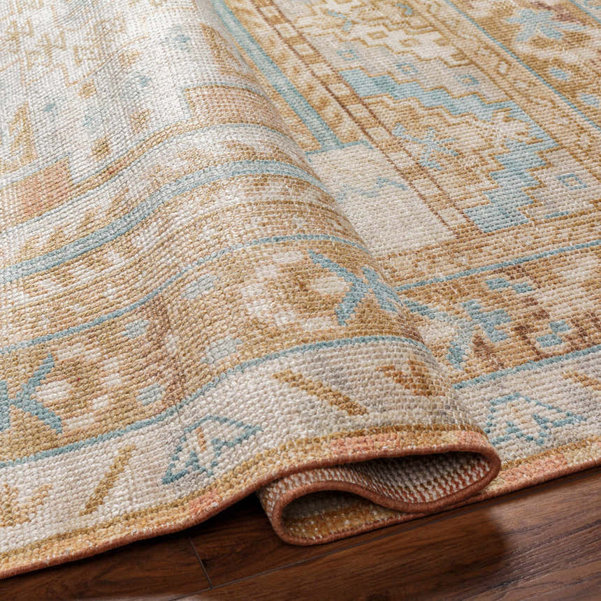 Close-up of the hand-knotted Aliang Premium Rug, featuring a traditional design in blue, camel, and cream wool. Fold