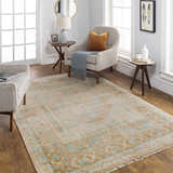 Living room scene with a tan and blue Aliang Premium Rug, neutral furniture, and wood floors. Roomscene-Rectangle