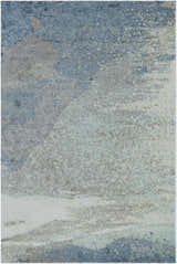 Close-up of the Alvaton Abstract Blue Rug showing its textured, machine-woven design in shades of blue, gray, and light beige. Design-Rectangle-23