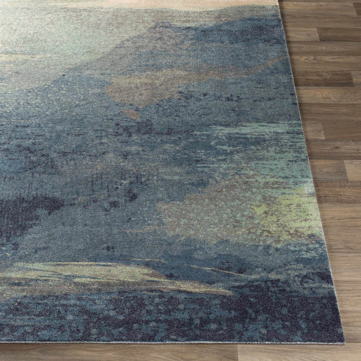 Close-up of the Alvaton Abstract Blue Rug showing its denim, gray, and light blue colors and contemporary abstract design. Front