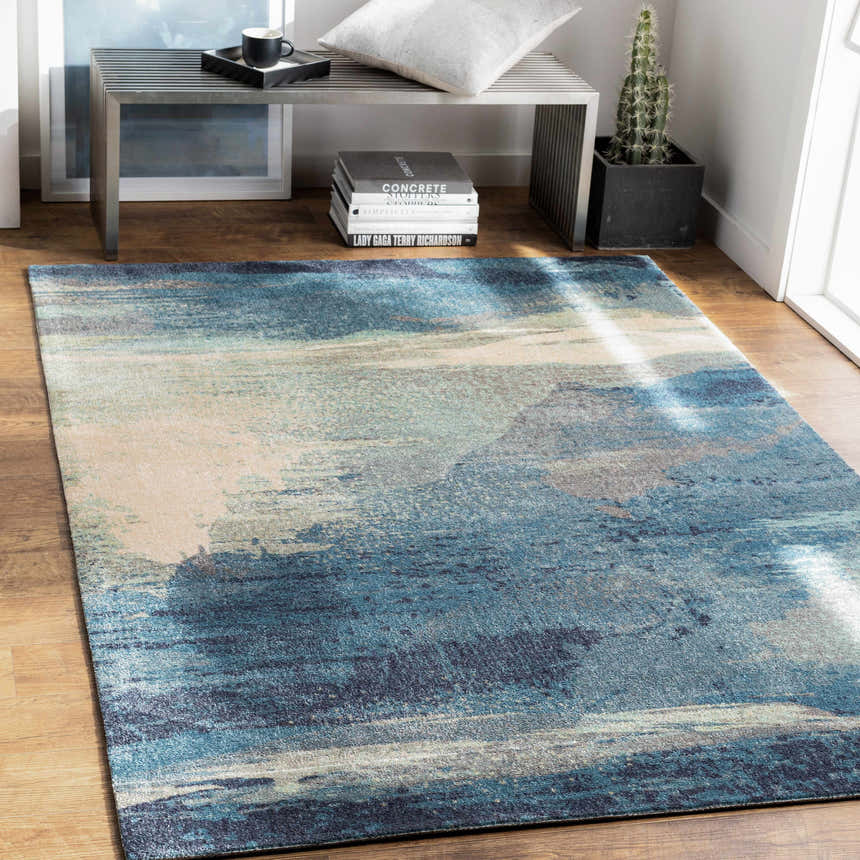 Entryway scene with Alvaton Abstract Blue Rug. Modern metal bench, wood floors, and light blue, gray, and beige tones. Roomscene-Rectangle