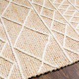 Close up of the Ambulong Area Rug's cream and tan wool texture with a raised geometric pattern. Hand woven rug detail. Texture