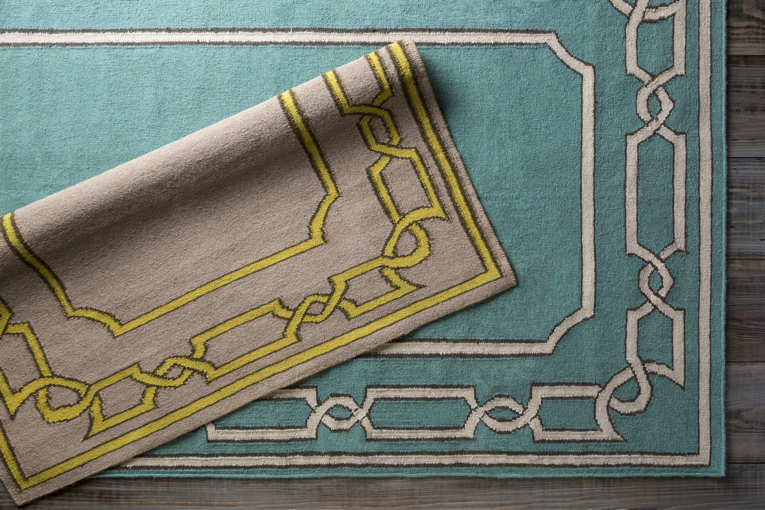 Close-up of Fruitvale Area Rug showing dark brown, tan, and taupe colors with a geometric hand woven design. Styleshot