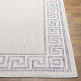 Close-up of Alen Cream & Blue Indoor Outdoor Rug showing Greek key border and textured weave on wood floor. Front