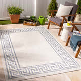 Outdoor patio scene with Alen Cream & Blue Indoor & Outdoor Rug, gray chairs, white side table, and potted plants. Roomscene-Rectangle