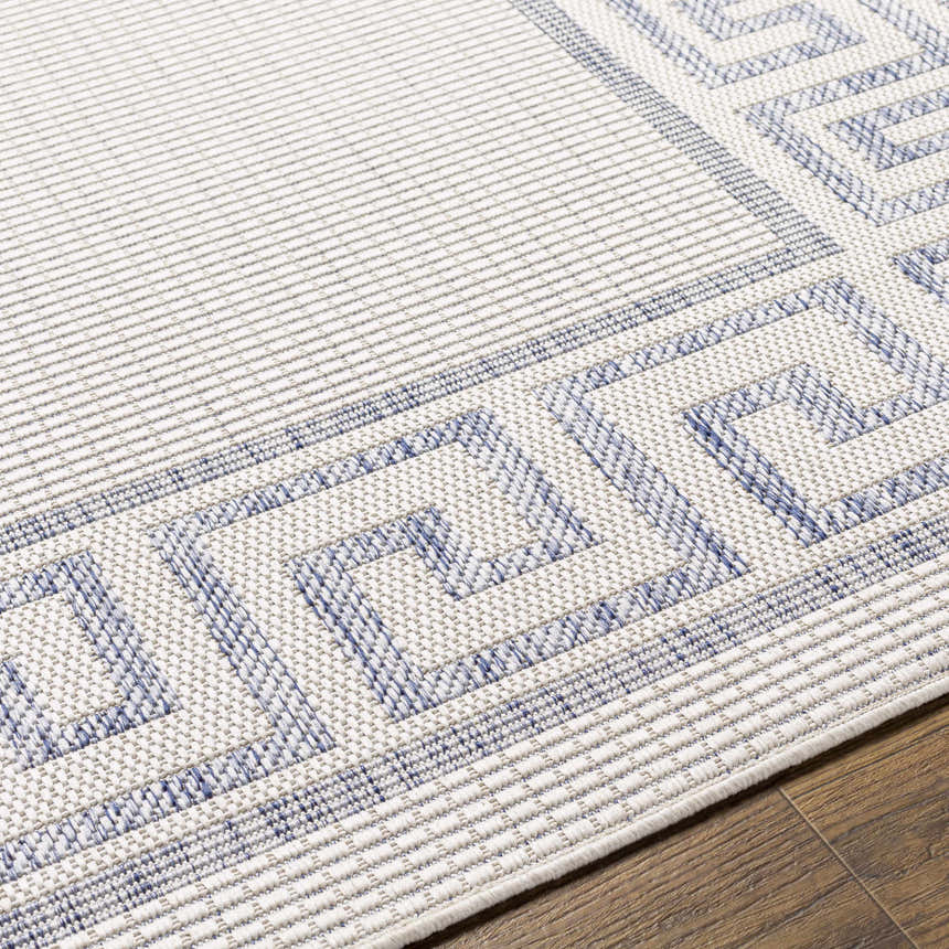 Close-up of the Alen Cream & Blue Indoor/Outdoor Rug showing a traditional Greek key border pattern and textured weave. Texture