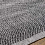 Close-up of the hand loomed Yong Gray Indoor Outdoor Rug showing texture and pattern. Texture