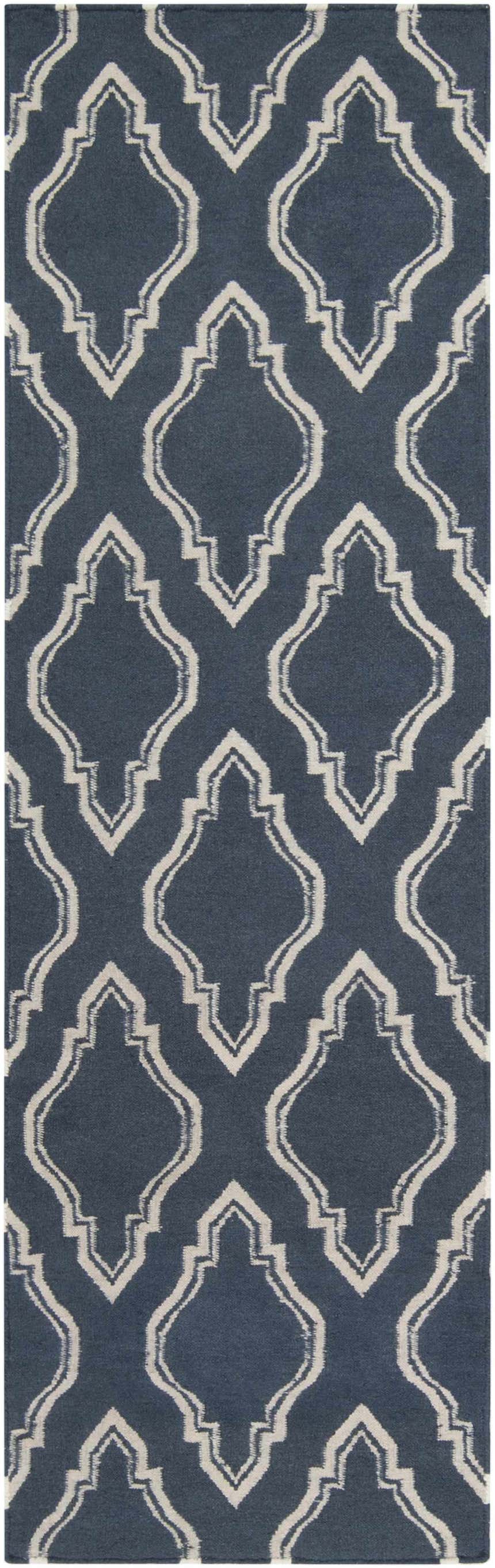 Close-up of the Anchorage Area Carpet, a hand-woven wool rug with a cream geometric pattern on a dark blue background. Design-Runner-268