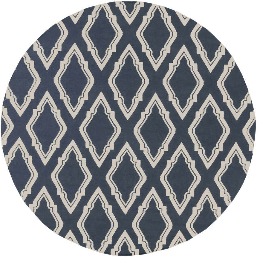 Close-up of round Anchorage Area Carpet. Cream geometric pattern on a dark blue, hand-woven wool rug. Design-Round