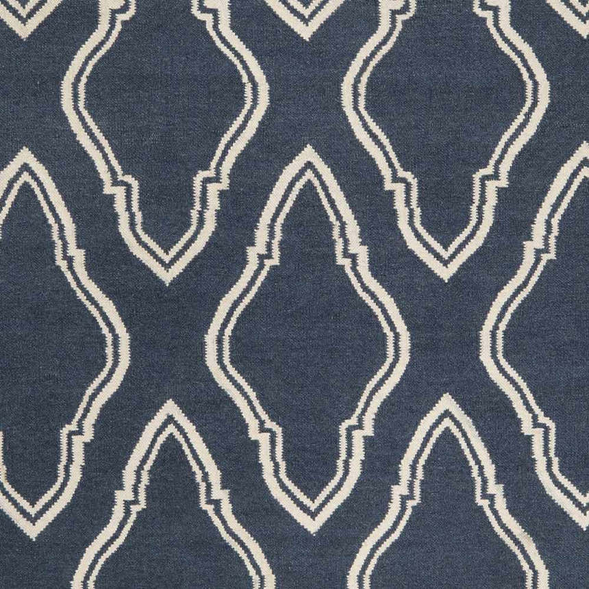 Close-up of Anchorage Area Carpet in dark blue and cream. Hand-woven wool rug with a geometric trellis pattern. Swatch