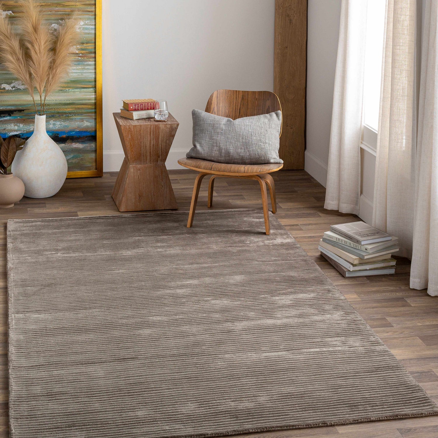 Neutral room scene with charcoal Angie Area Rug, wood chair, side table, and art. Roomscene-Rectangle