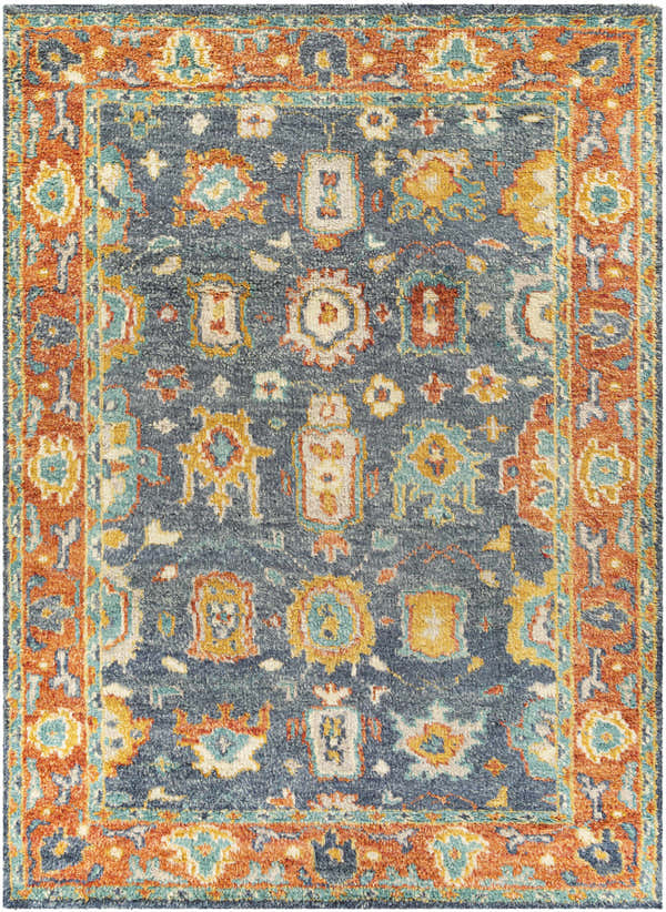 Close-up of the Ankara Premium Wool Area Rug, featuring a traditional design in aqua, orange, and navy. Hand-knotted texture. Design-Rectangle-912