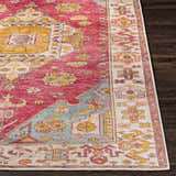 Close-up of the Anopog Washable Area Rug. Farmhouse style rug with red, yellow, and blue traditional patterns. Front