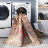 Laundry room scene with Anopog Washable Area Rug coming out of a washing machine. Farmhouse style, red, yellow, and blue colors. Washing-Machine