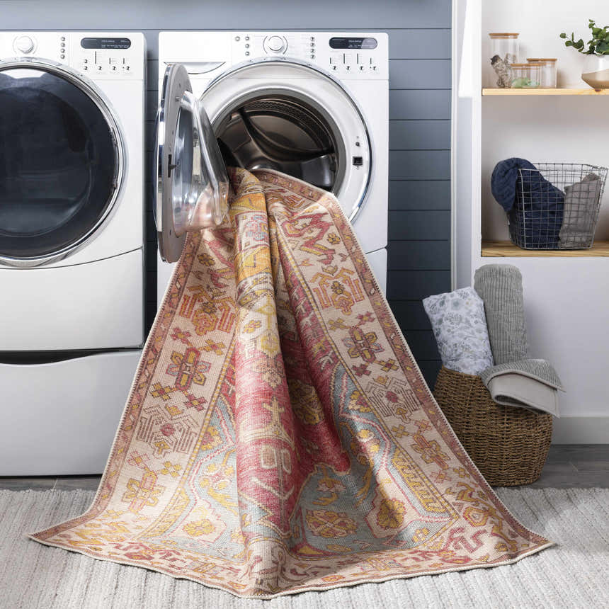 Laundry room scene with Anopog Washable Area Rug coming out of a washing machine. Farmhouse style, red, yellow, and blue colors. Washing-Machine