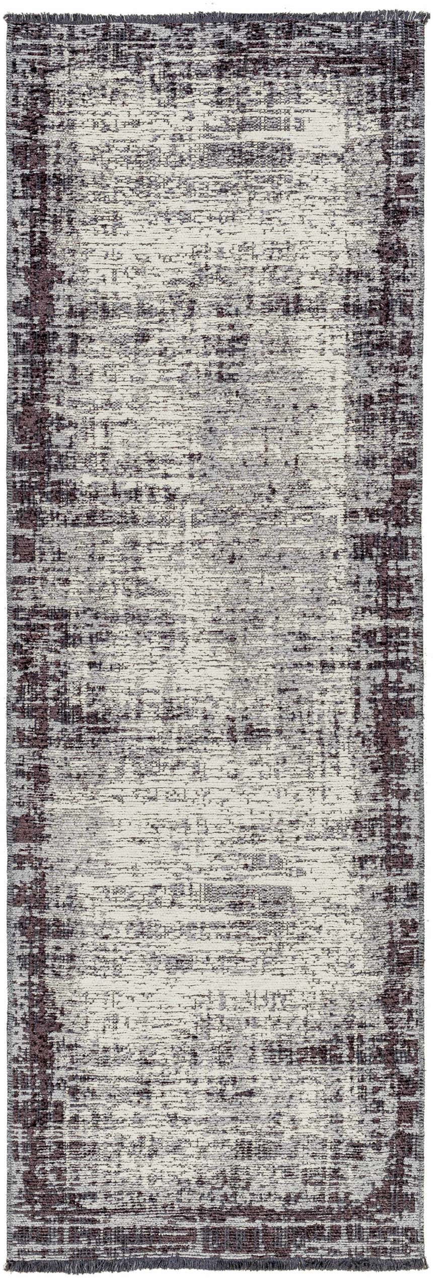 Close-up of the Binh Gray Area Rug, a contemporary rug with charcoal, cream, and slate hues and a distressed design. Design-Runner
