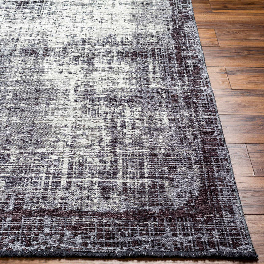 Close-up of Binh Gray Area Rug showing charcoal, cream, and slate colors with a contemporary, distressed design. Front
