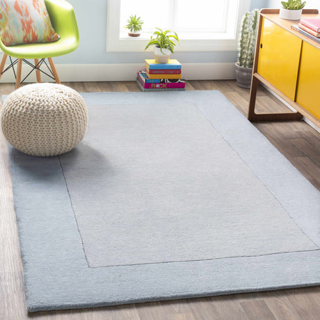 Arkabutla Solid Blue Bordered Wool Rug