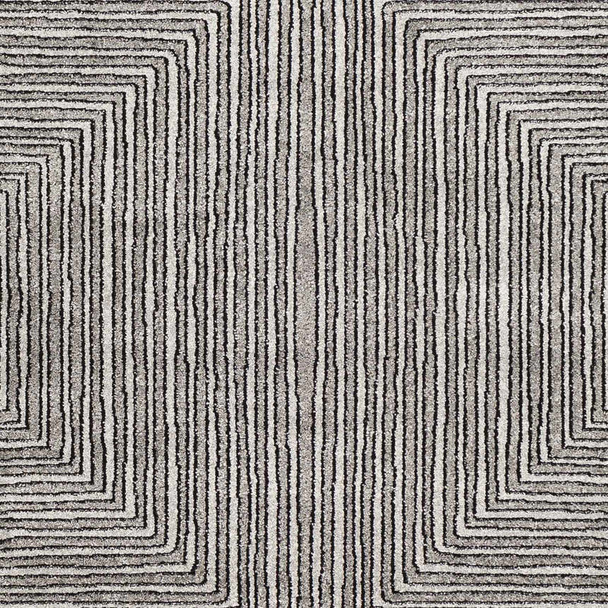 Close-up of the Artois Area Rug. Black, cream, and gray rug with a modern geometric pattern and textured jute weave. Swatch