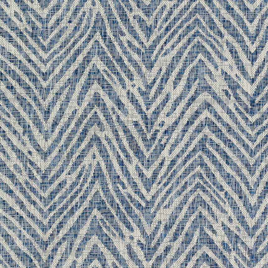Close-up of the Ashcamp Area Rug. Coastal style rug with a blue and taupe chevron pattern and textured weave. Swatch