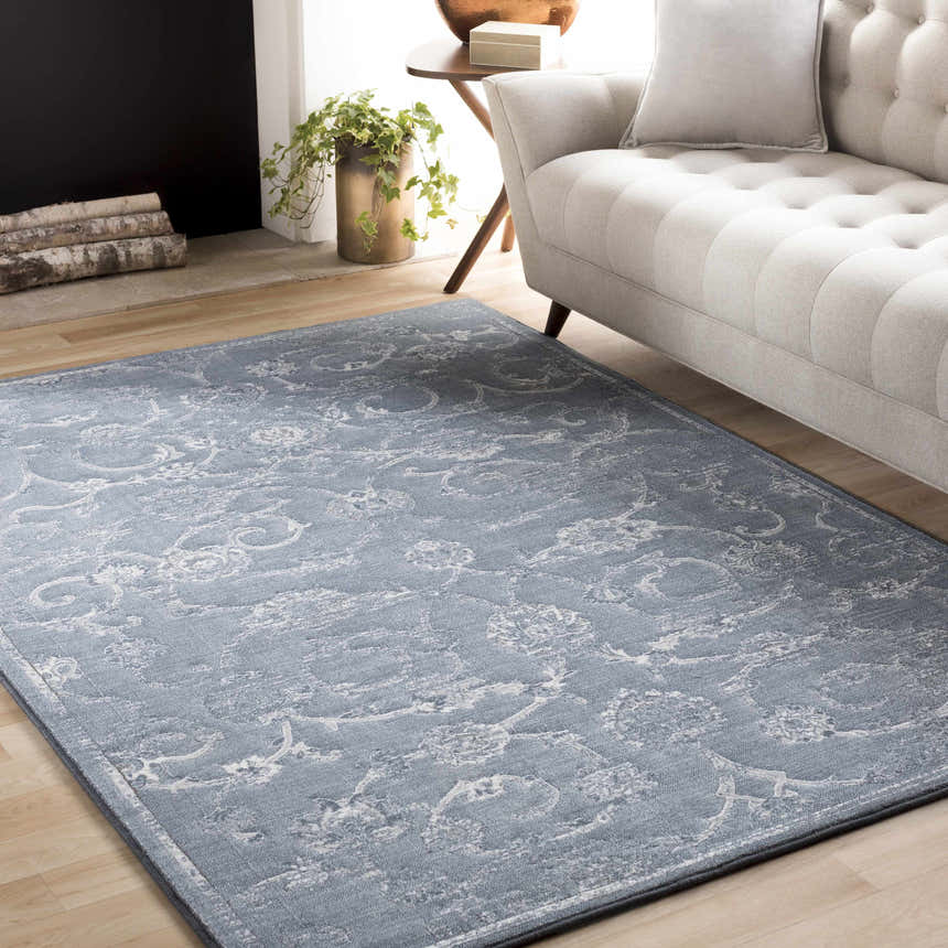 Living room scene with a blue Astatula Area Rug, light gray sofa, fireplace, and wood floors. Roomscene-Rectangle