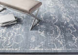 Close-up of the Astatula Area Rug, a blue and ivory vintage style rug with a traditional floral pattern. Styleshot