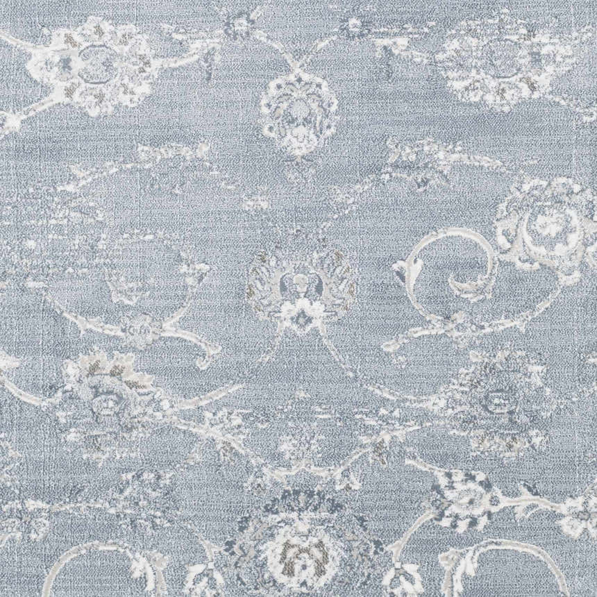 Close-up of Astatula Area Rug: blue, ice blue, and ivory floral pattern. Machine woven polypropylene rug. Swatch