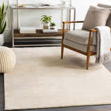 Living room scene with beige Atlas Carpet, modern chair, and console table. Roomscene-Rectangle