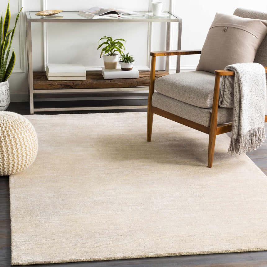 Living room scene with beige Atlas Carpet, modern chair, and console table. Roomscene-Rectangle