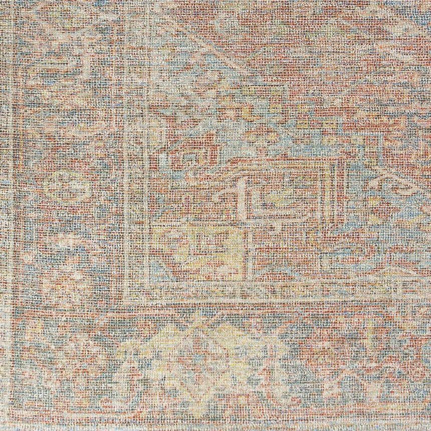 Close-up of the hand woven Atulayan Premium Rug with a traditional pattern in blue, burgundy, and light gray. Swatch