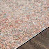 Close-up of the hand woven Atulayan Premium Rug, showcasing its blue, coral, and beige bohemian pattern and textured weave. Texture