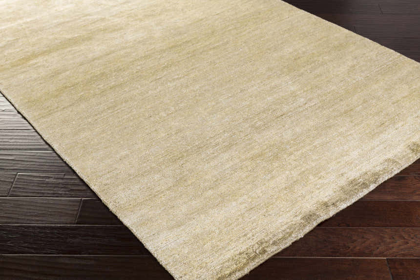 Close up of the olive Aumsville Area Rug showing its hand woven texture and subtle sheen. Corner