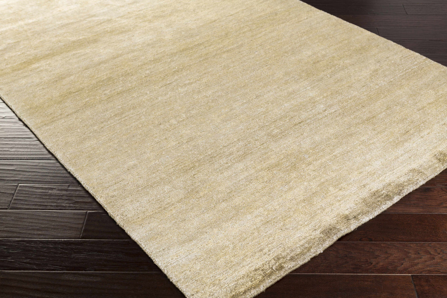 Close up of the olive Aumsville Area Rug showing its hand woven texture and subtle sheen. Corner