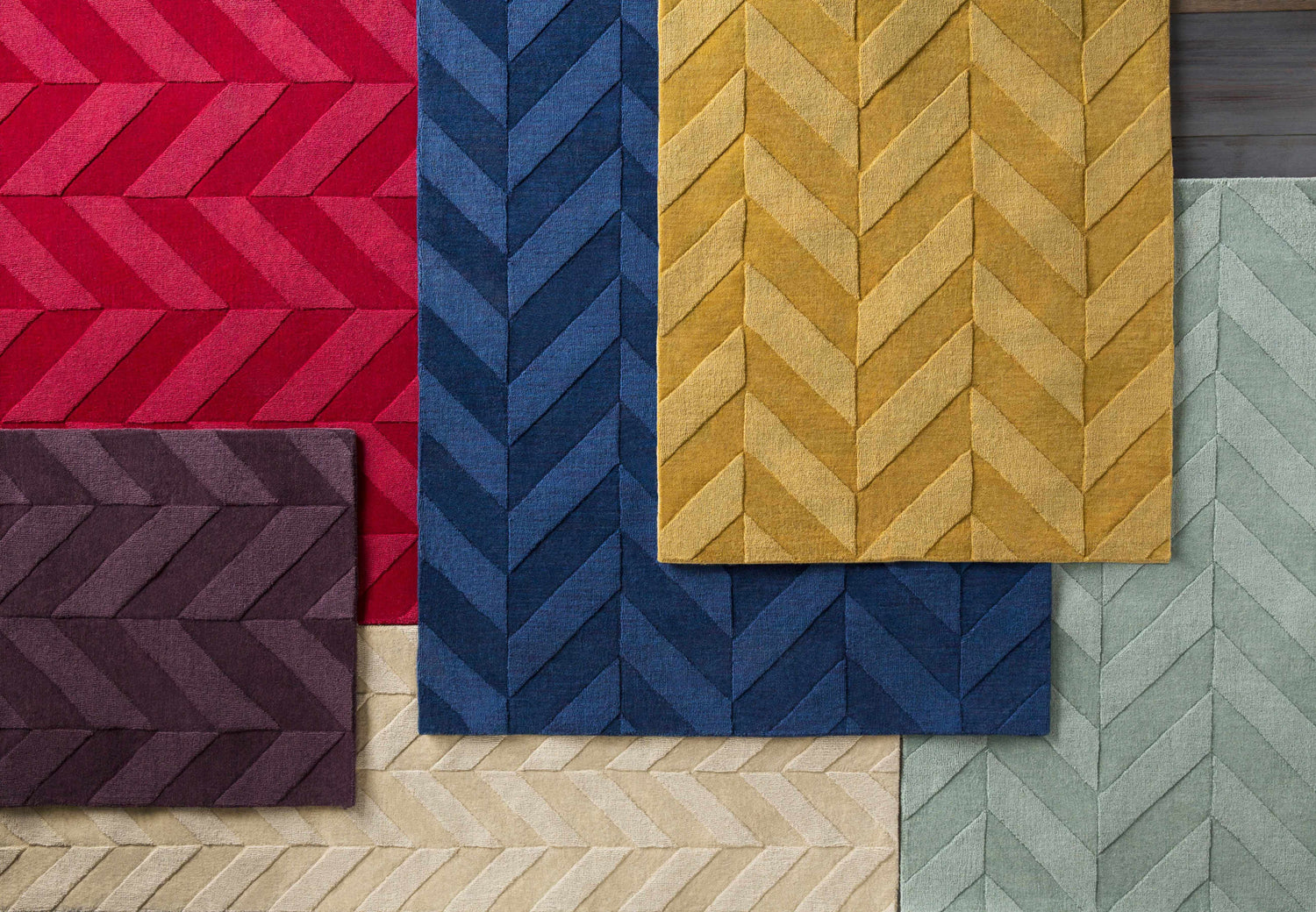 Close-up of Searsmont Area Rug in red, navy, gold, plum, beige, and light blue, featuring a textured chevron pattern. Styleshot