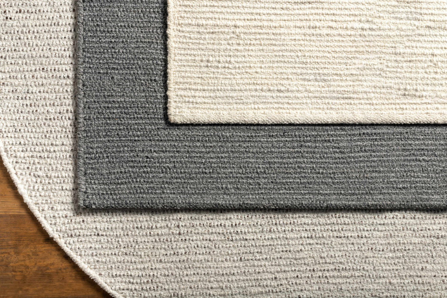Close-up of the Innisfail Area Rug showing the black and medium gray striped pattern and hand woven texture. Styleshot