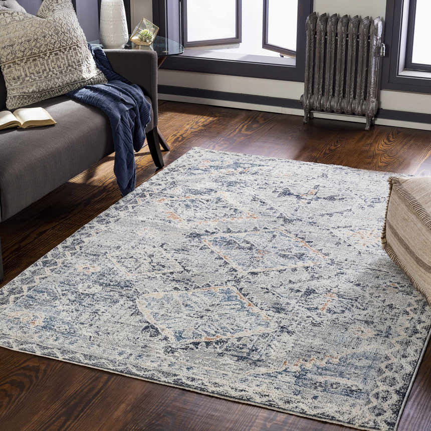 Living room scene with a Balamban Area Rug in brick red, cream, denim, and gray colors on a dark wood floor. Roomscene-Rectangle